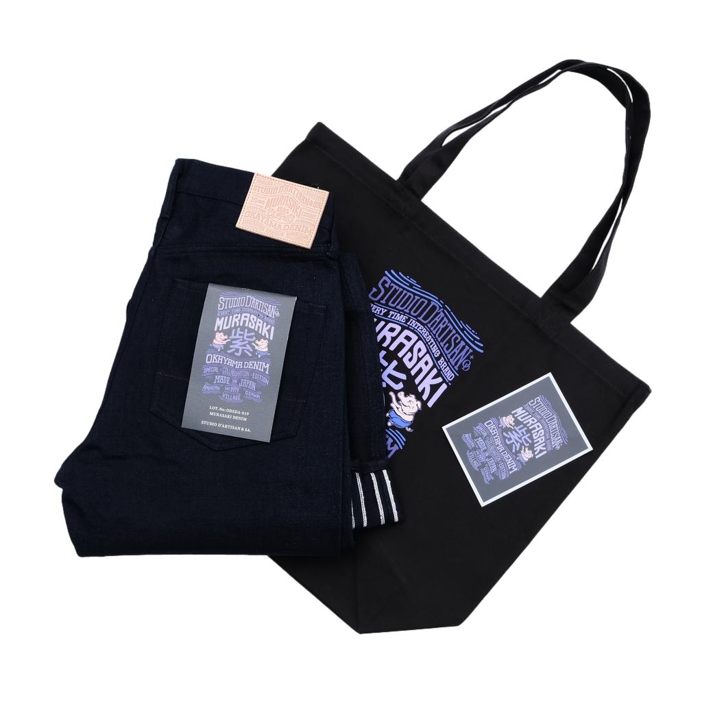 Black tote bag with printed design and text on a white background